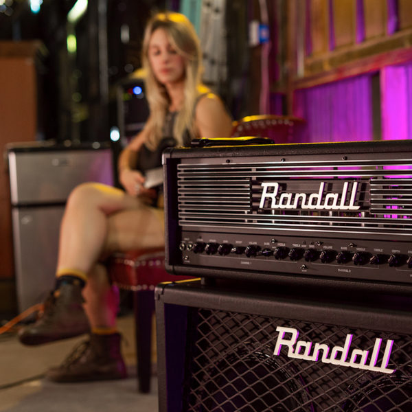 Randall Thrasher Tube Amplifier with woman playing electric guitar in background